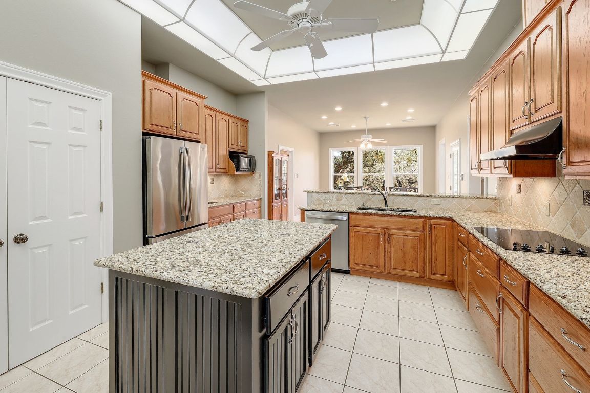 200 High River Ranch Drive Liberty Hill, TX 78642 - Photo 9 of 39 a kitchen with stainless steel appliances granite countertop a sink stove and refrigerator