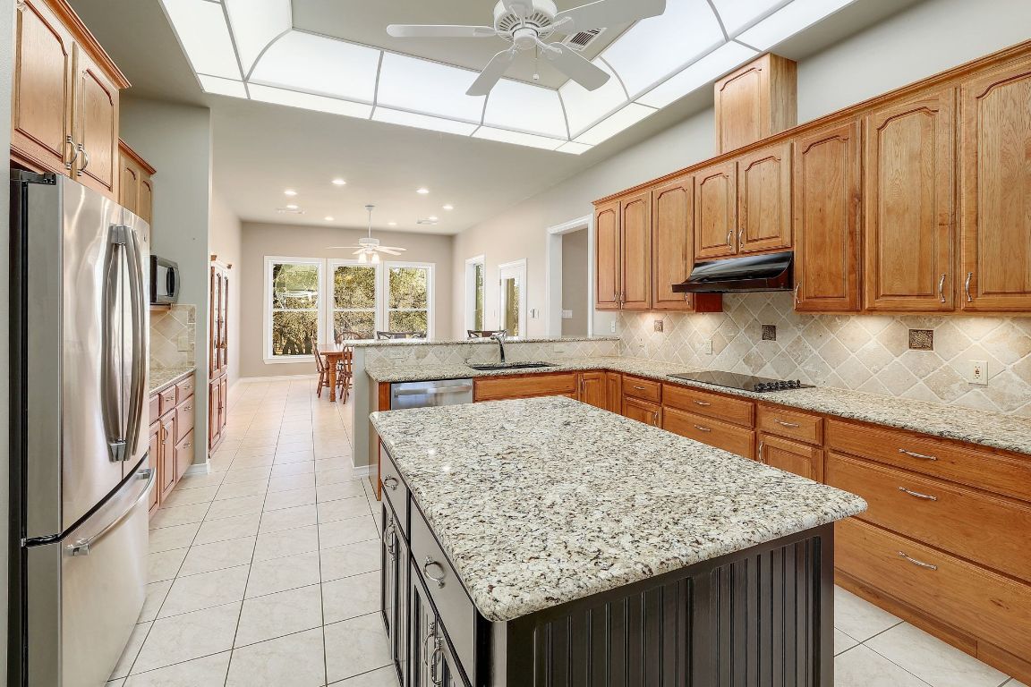 200 High River Ranch Drive Liberty Hill, TX 78642 - Photo 10 of 39 a kitchen with stainless steel appliances granite countertop a counter space a sink and cabinets