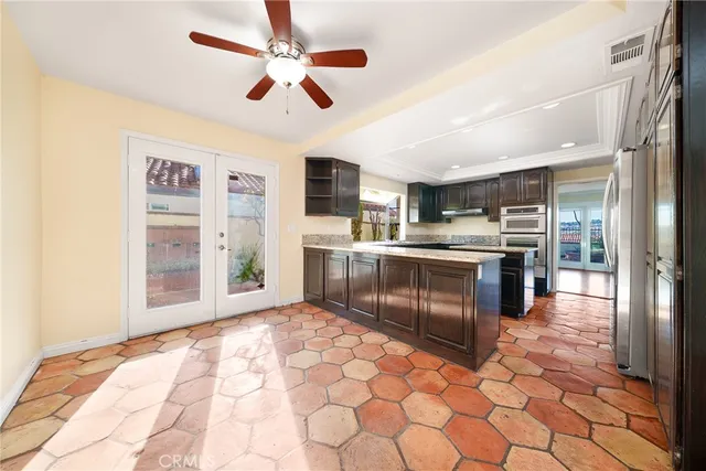a kitchen with stainless steel appliances granite countertop a stove sink and cabinets