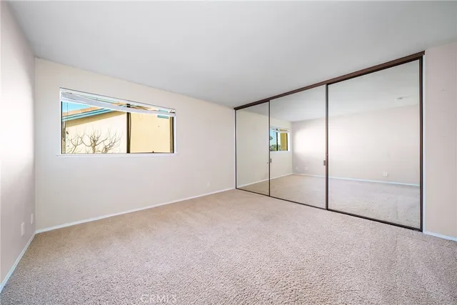 an empty room with windows and closet