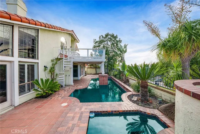 a view of an house with backyard space and sitting area