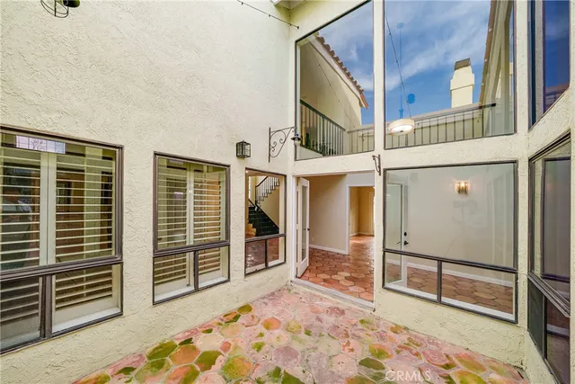 a view of a house with a barbeque and wooden stairs