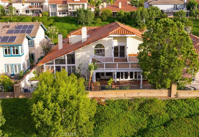 an aerial view of a house with swimming pool and porch