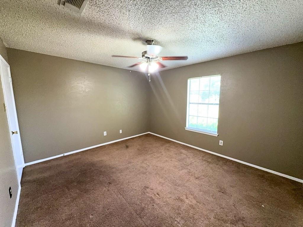 1613 Edgehill Road Benbrook, TX 76126 - Photo 15 of 22 an empty room with a window and a fan