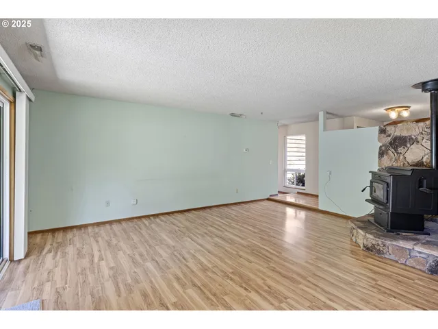 a view of an empty room with a chandelier fan