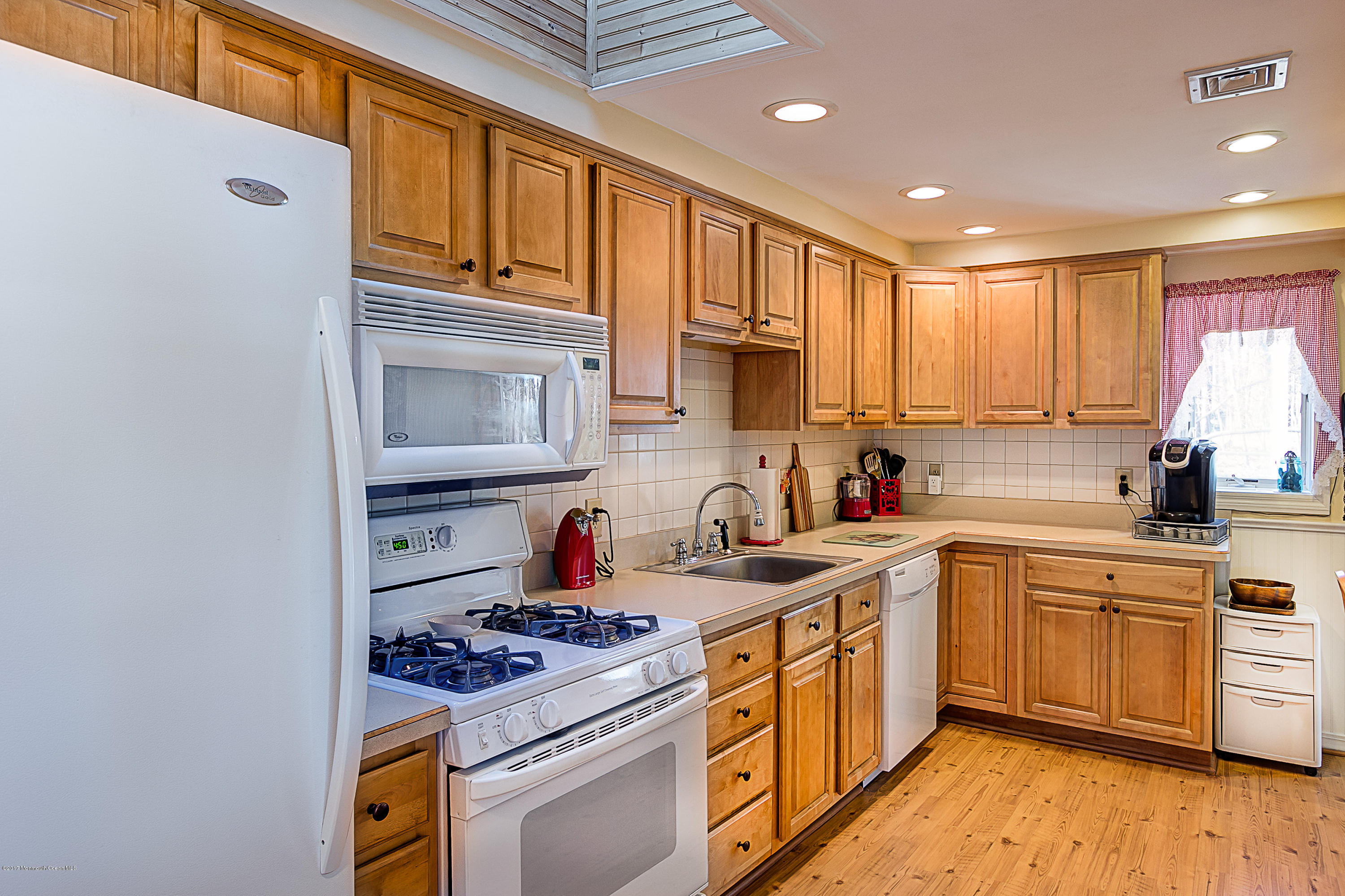 95 Siloam Road Freehold, NJ 07728 - Photo 4 of 23 a kitchen with a sink stove and cabinets