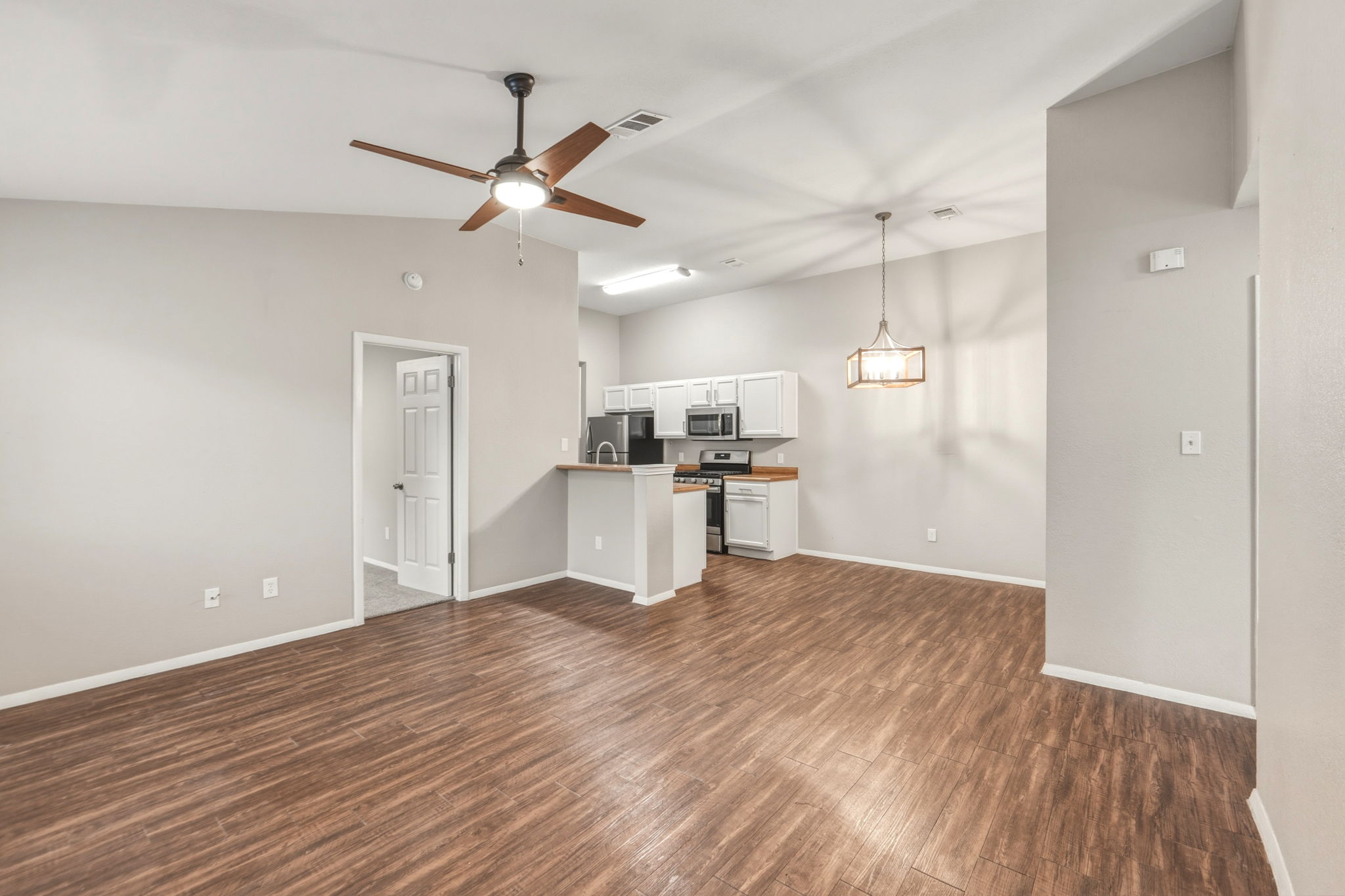 a view of a kitchen with wooden floor and a kitchen