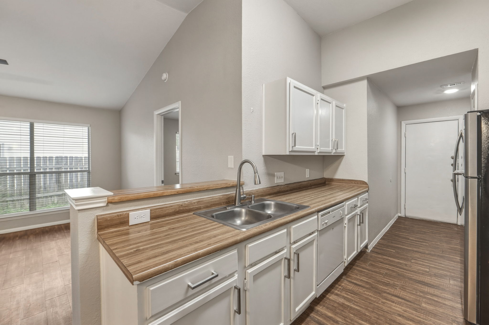 2302 Fuzz Fairway, Unit A Austin, TX 78728 - Photo 11 of 32 a kitchen with stainless steel appliances granite countertop a sink stove and cabinets