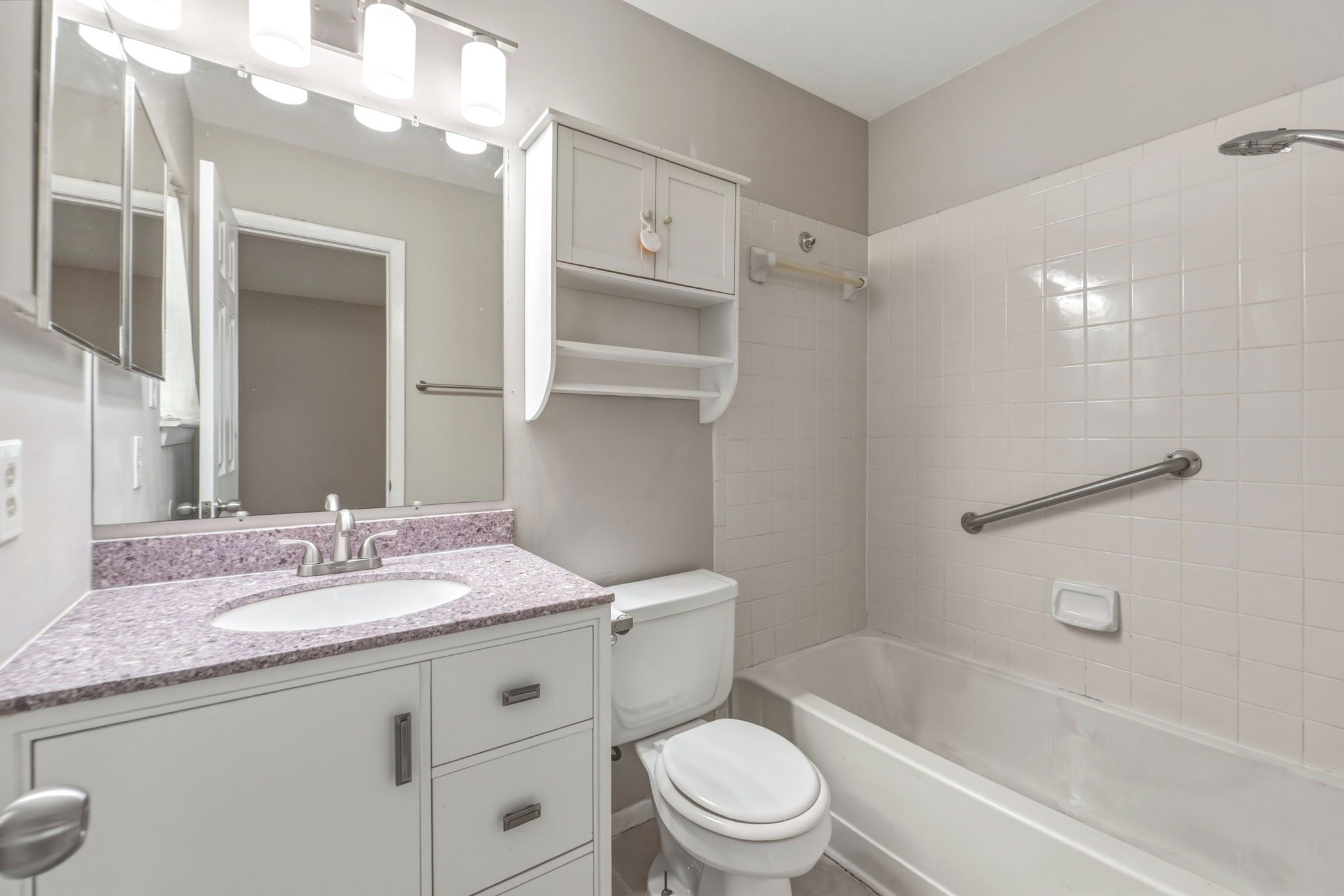 2302 Fuzz Fairway, Unit A Austin, TX 78728 - Photo 16 of 32 a bathroom with a granite countertop sink a toilet and shower