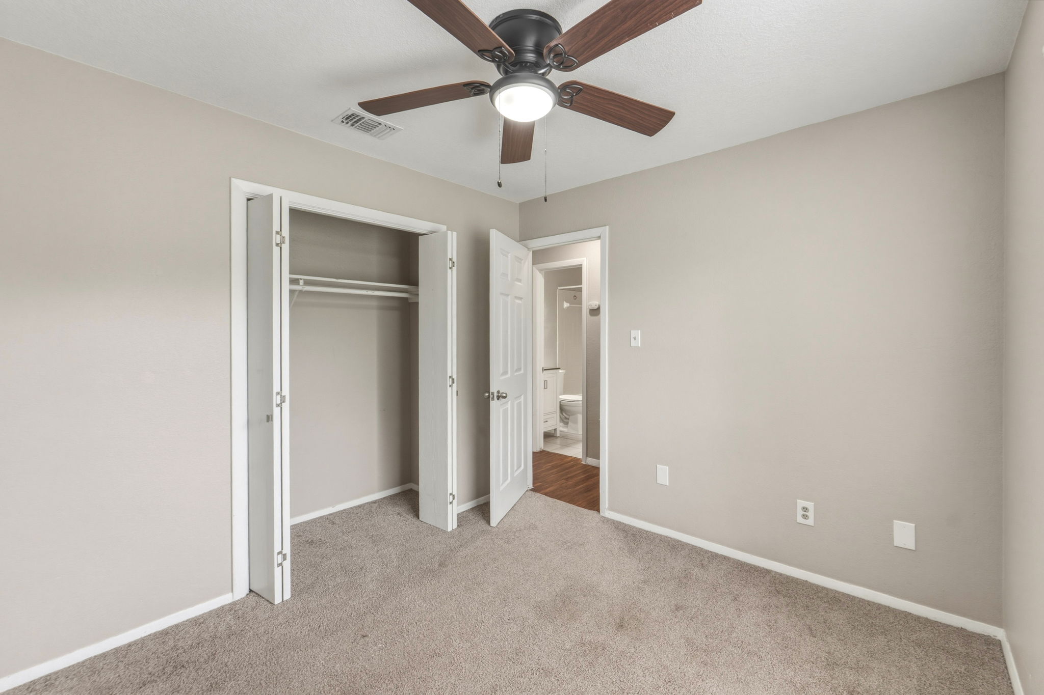 2302 Fuzz Fairway, Unit A Austin, TX 78728 - Photo 19 of 32 an empty room with closet and a ceiling fan