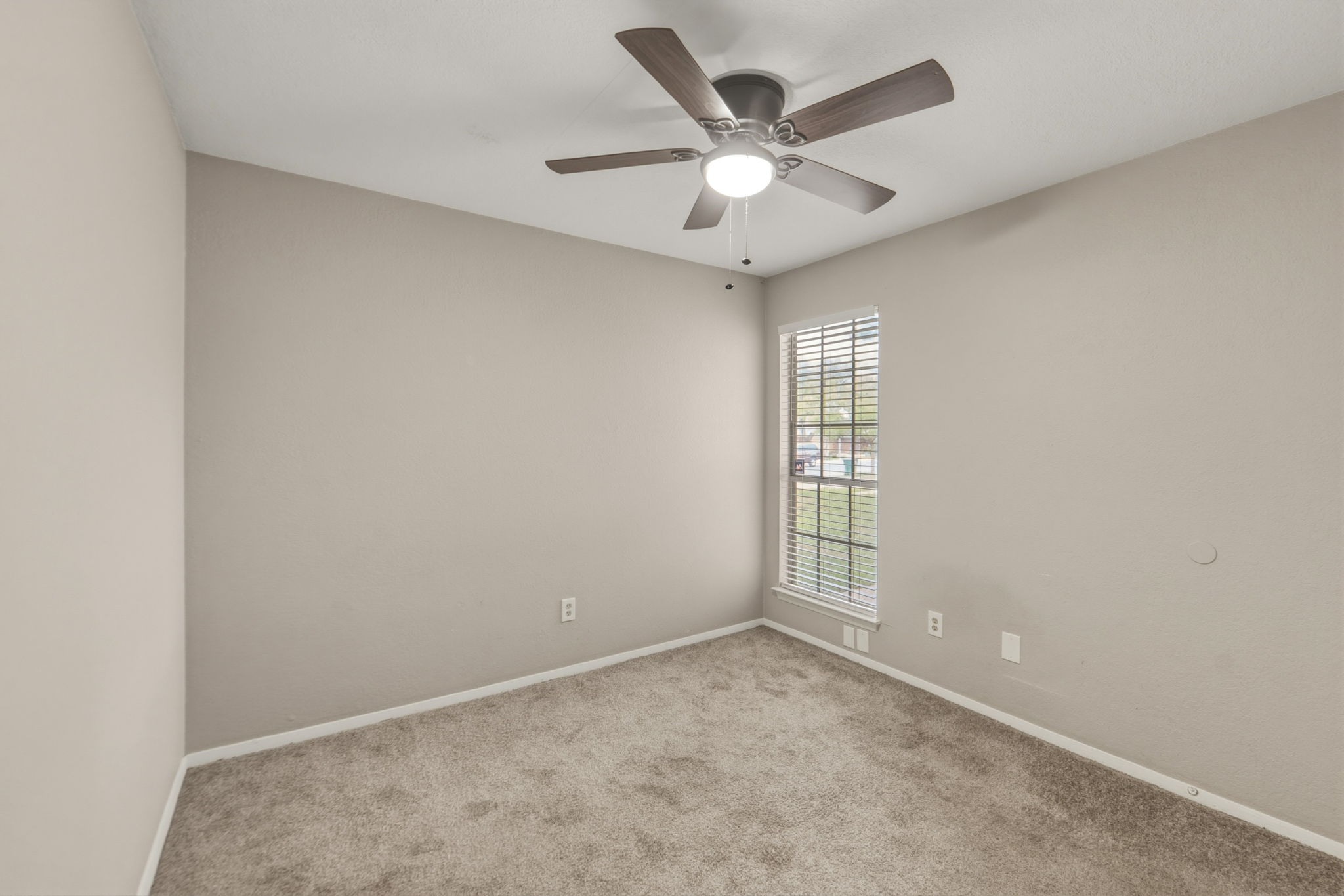 2302 Fuzz Fairway, Unit A Austin, TX 78728 - Photo 22 of 32 an empty room with a ceiling fan and window