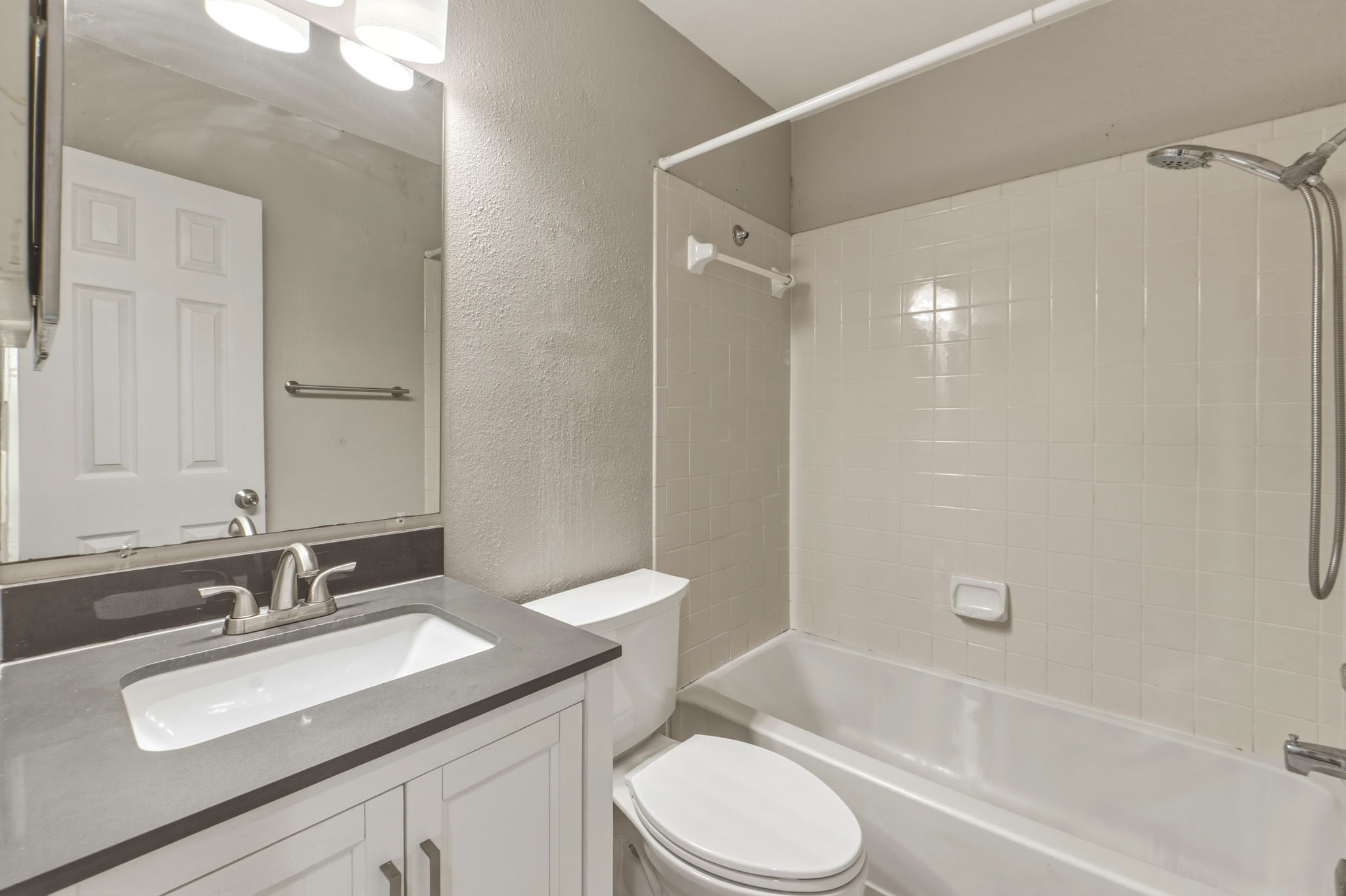 2302 Fuzz Fairway, Unit A Austin, TX 78728 - Photo 24 of 32 a bathroom with a granite countertop sink toilet and shower