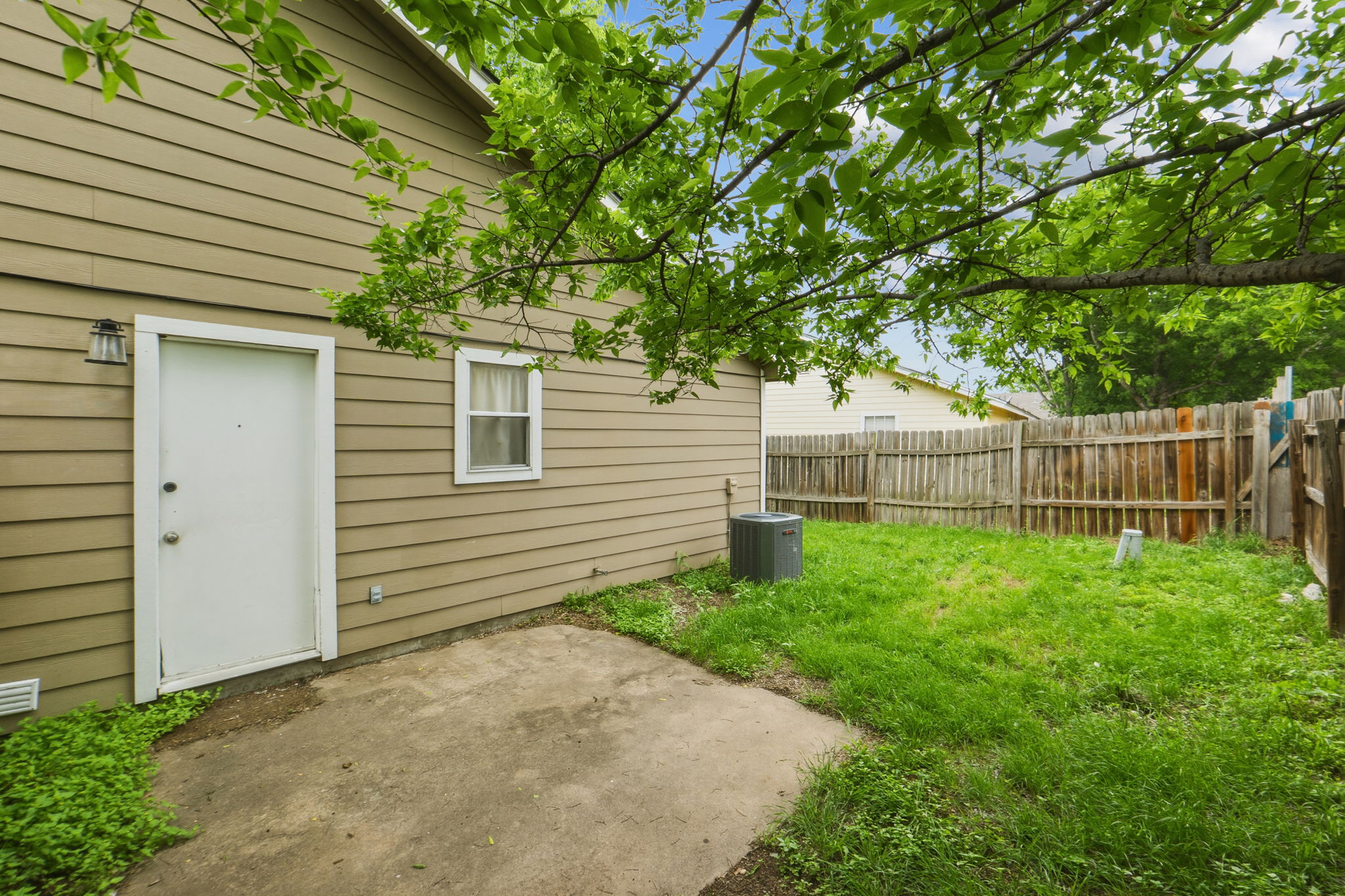 2302 Fuzz Fairway, Unit A Austin, TX 78728 - Photo 27 of 32 a view of a backyard with plants and wooden fence