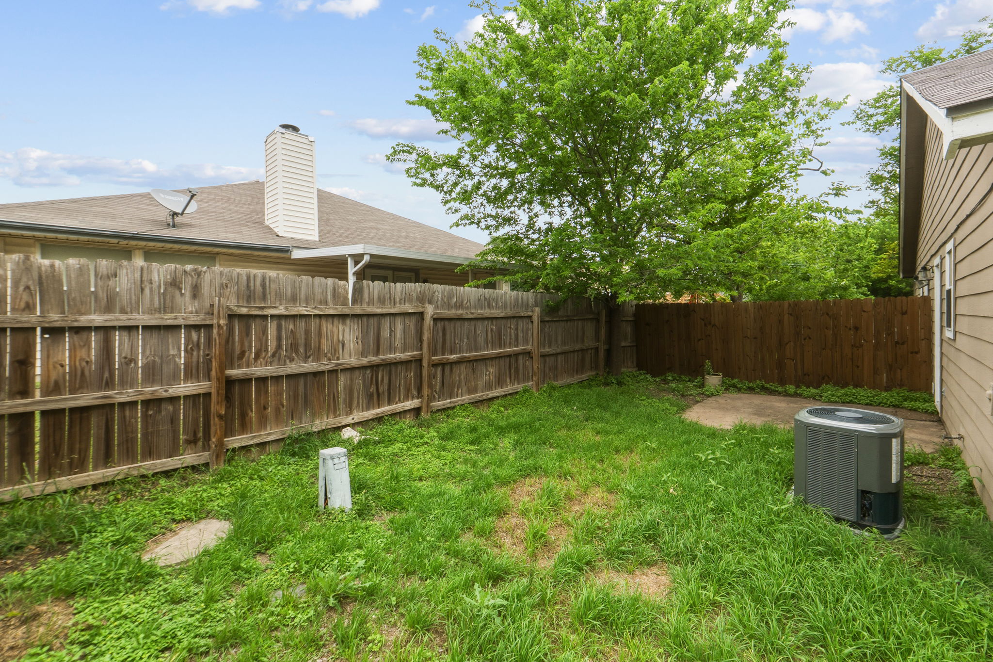 2302 Fuzz Fairway, Unit A Austin, TX 78728 - Photo 29 of 32 a view of a backyard with a small cabin and a chair