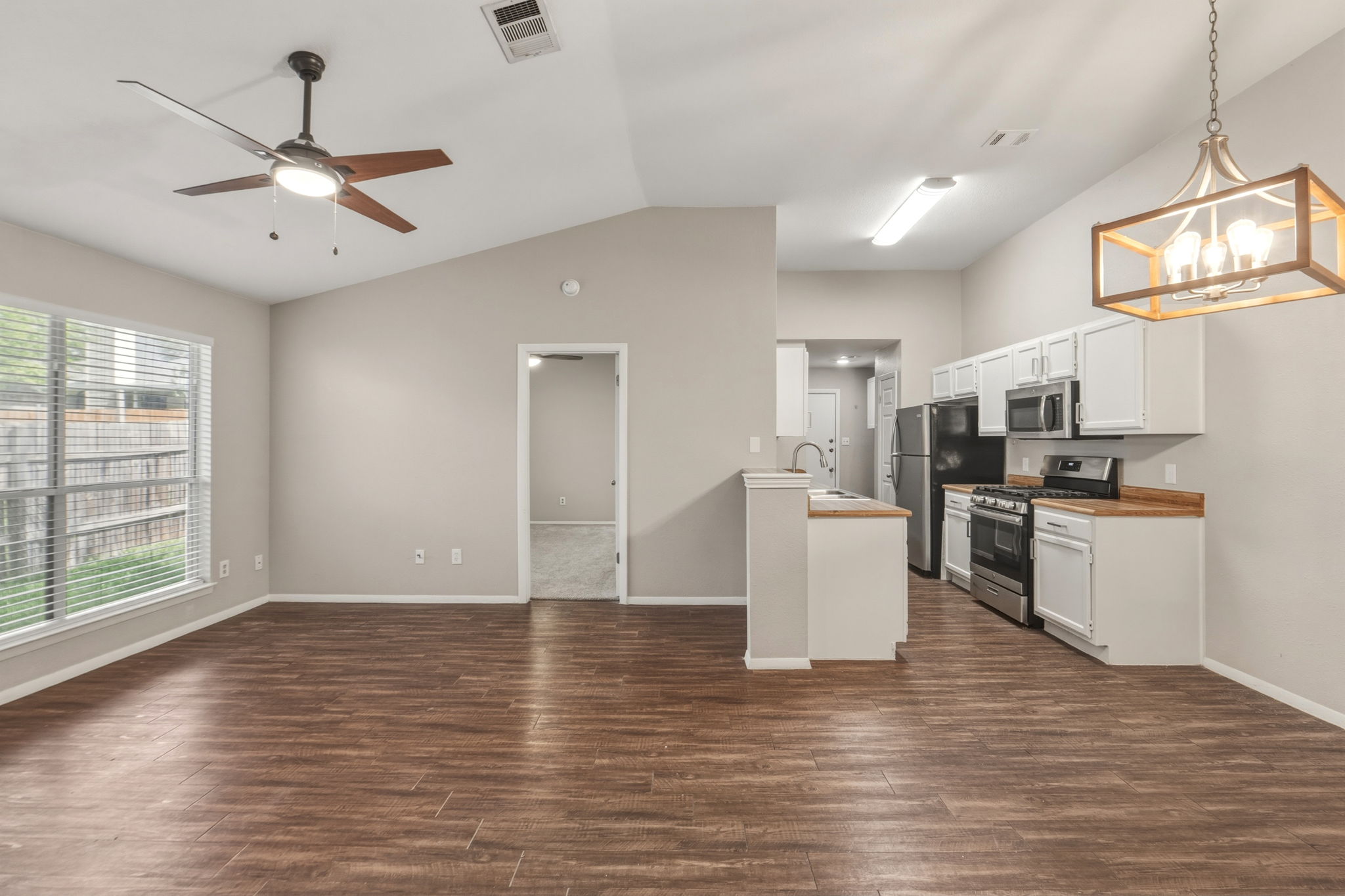 2302 Fuzz Fairway, Unit A Austin, TX 78728 - Photo 3 of 32 a view of kitchen with microwave a stove and wooden floor