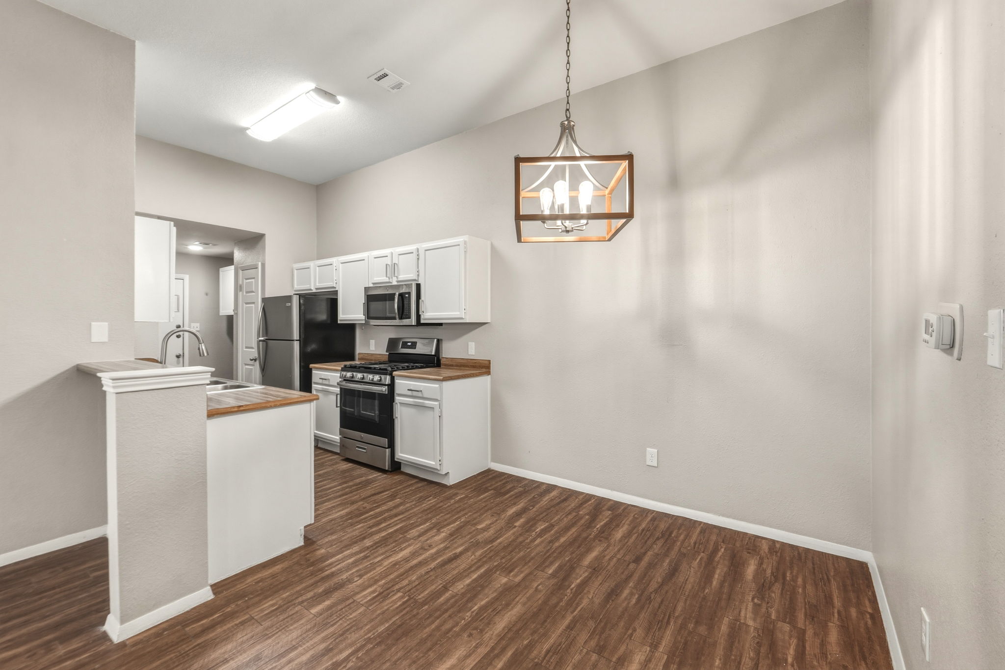 2302 Fuzz Fairway, Unit A Austin, TX 78728 - Photo 6 of 32 a kitchen with a refrigerator and a stove top oven