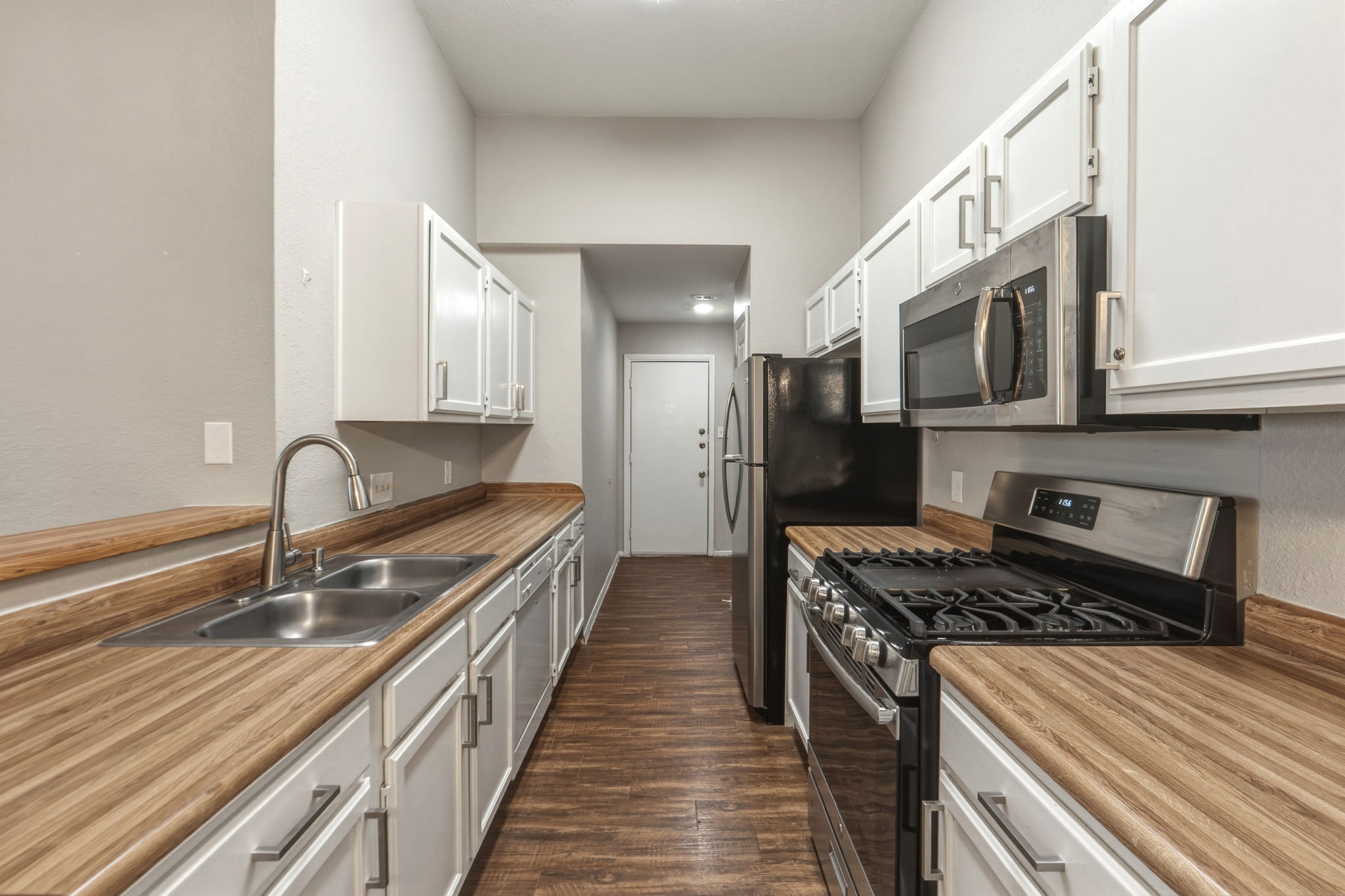 2302 Fuzz Fairway, Unit A Austin, TX 78728 - Photo 8 of 32 a kitchen with stainless steel appliances granite countertop a sink stove and refrigerator
