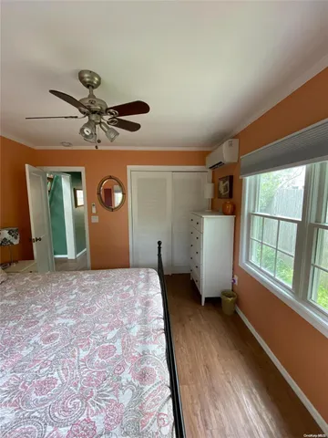 a view of a livingroom with a ceiling fan and window