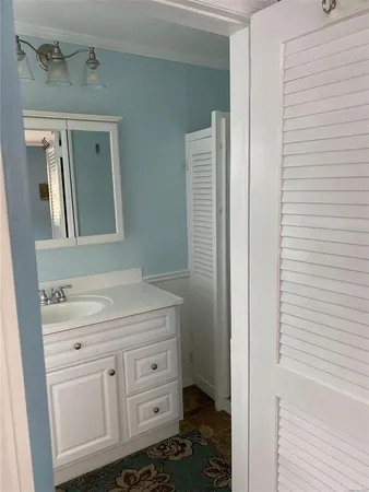 a bathroom with a sink a light fixture and a toilet