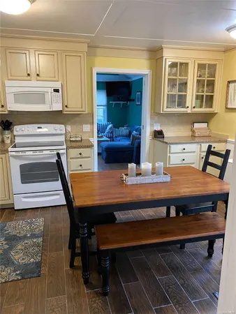 a view of a kitchen with a table and chairs