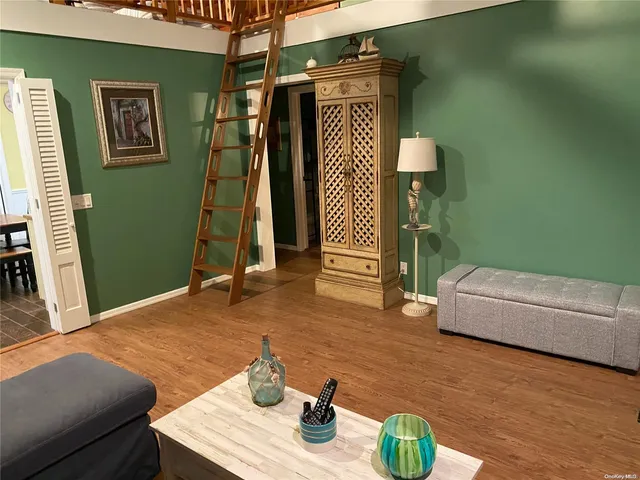 a bedroom with furniture and a wooden floor