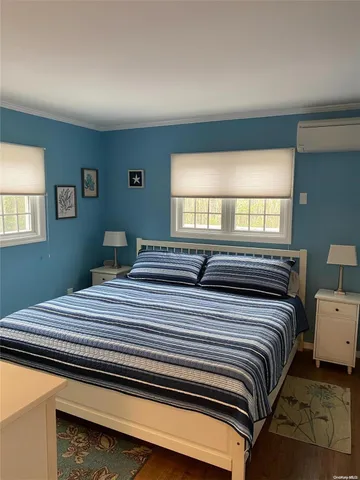 a bedroom with bed and window