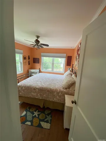 a bedroom with a bed and a mirror