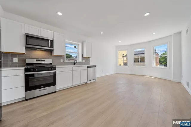 a kitchen with stainless steel appliances a stove and a refrigerator