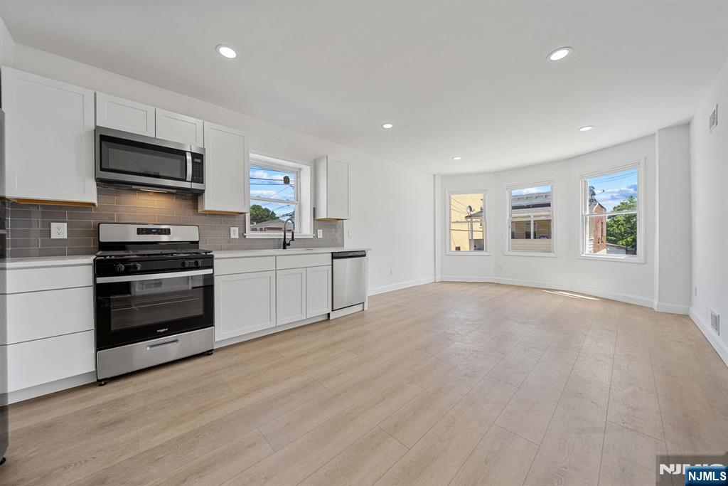a kitchen with stainless steel appliances a stove and a refrigerator