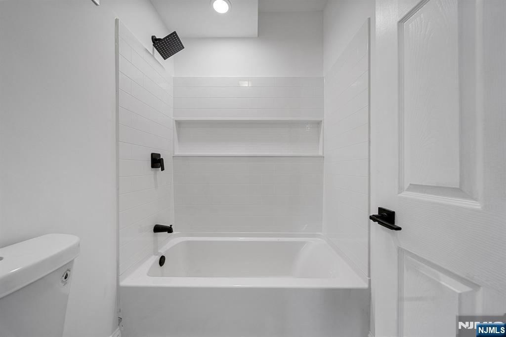 61 Farnham Avenue, Unit 1 Garfield, NJ 07026 - Photo 14 of 14 a bathroom with a bathtub
