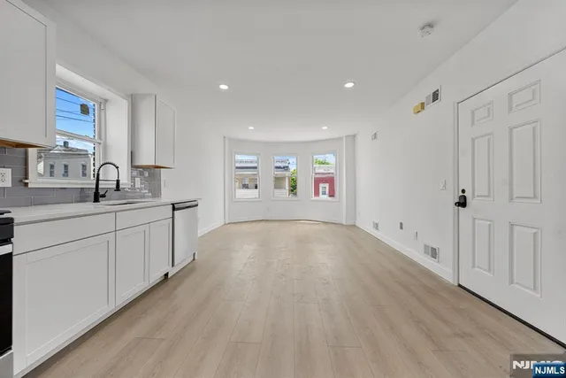 a view of a kitchen with a sink and a window