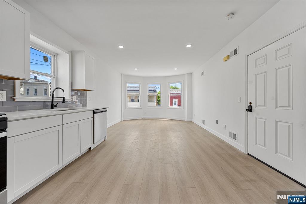 61 Farnham Avenue, Unit 1 Garfield, NJ 07026 - Photo 4 of 14 a view of a kitchen with a sink and a window