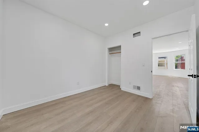 wooden floor in a hall with an empty room