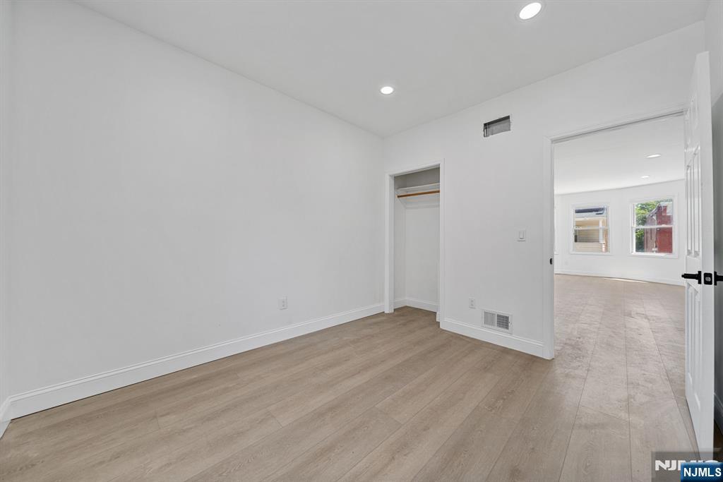61 Farnham Avenue, Unit 1 Garfield, NJ 07026 - Photo 9 of 14 wooden floor in a hall with an empty room