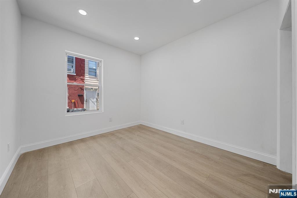 61 Farnham Avenue, Unit 1 Garfield, NJ 07026 - Photo 10 of 14 an empty room with windows