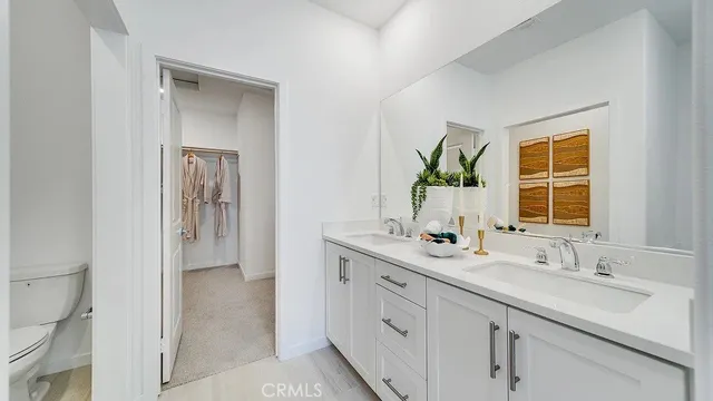 a bathroom with a sink double vanity and a mirror