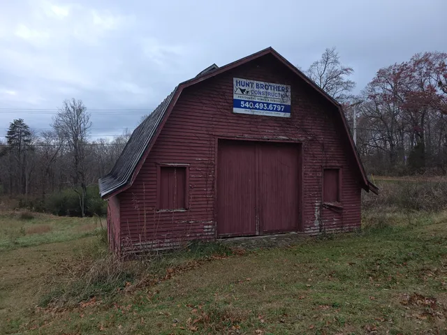 a view of a small barn with a small yard