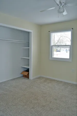 a view of house with a backyard