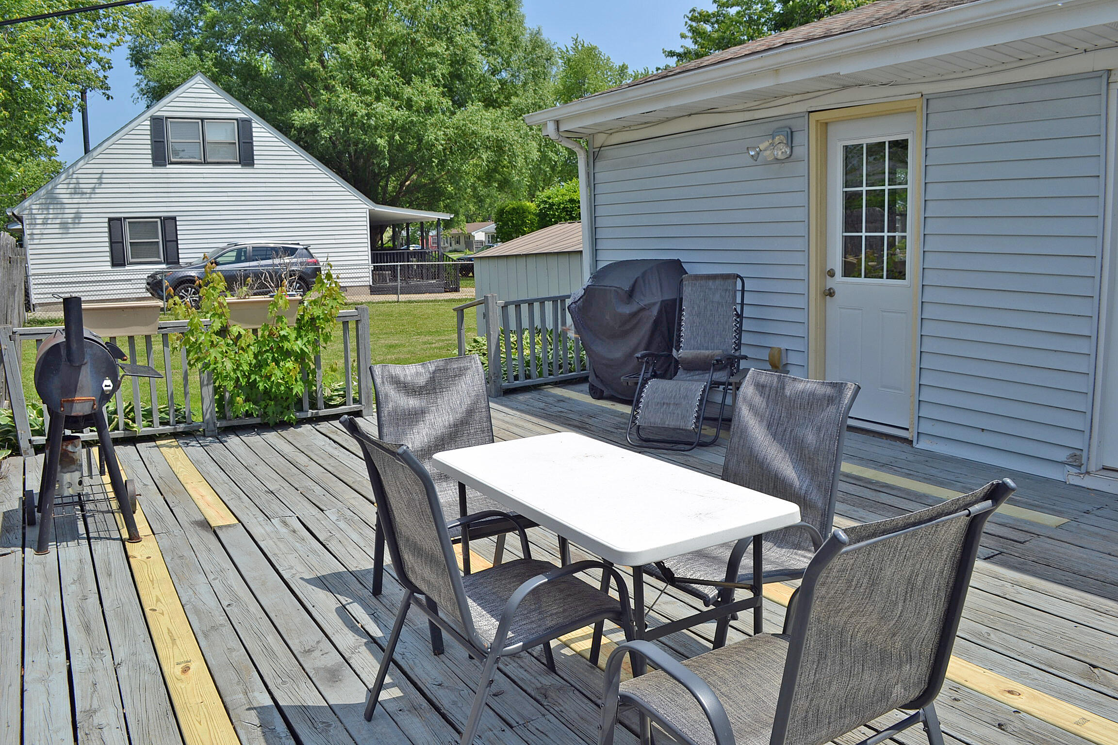 740 Imperial Road Valparaiso, IN 46385 - Photo 26 of 30 a view of a patio with table and chairs with wooden floor and fence