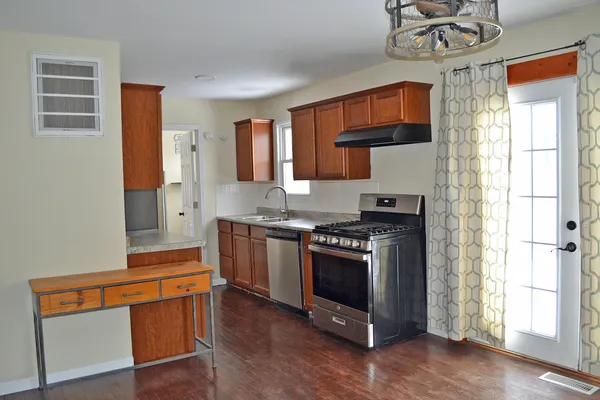 a kitchen with stainless steel appliances granite countertop a stove and a refrigerator