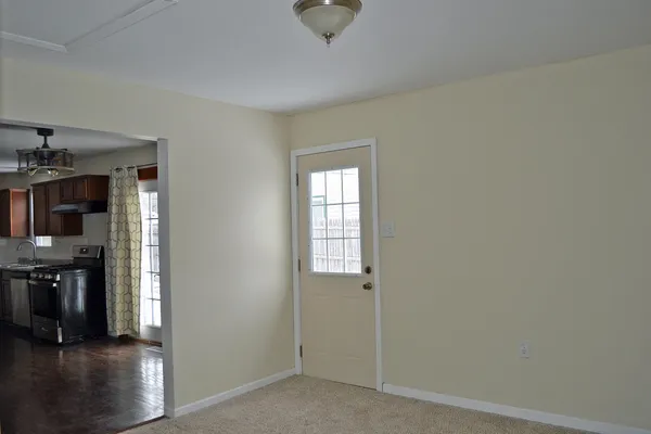 an empty room with closet and windows