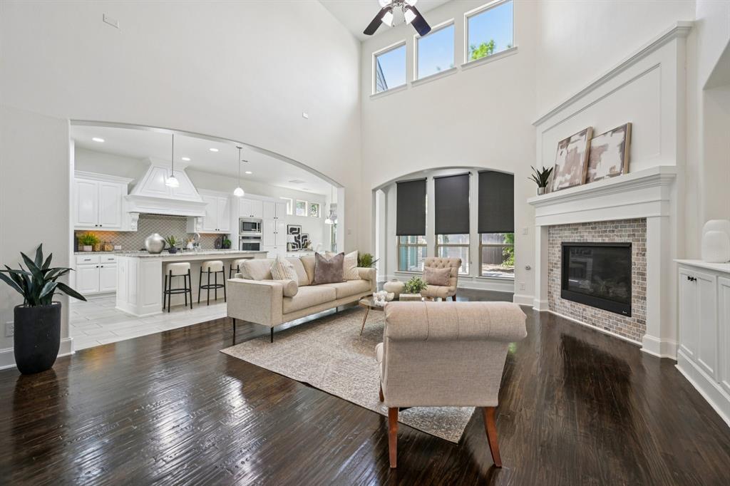 2029 Temperate Drive Allen, TX 75013 - Photo 6 of 40 a living room with furniture or wooden floor and a fireplace