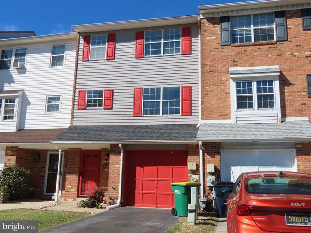 a view of building with car parked
