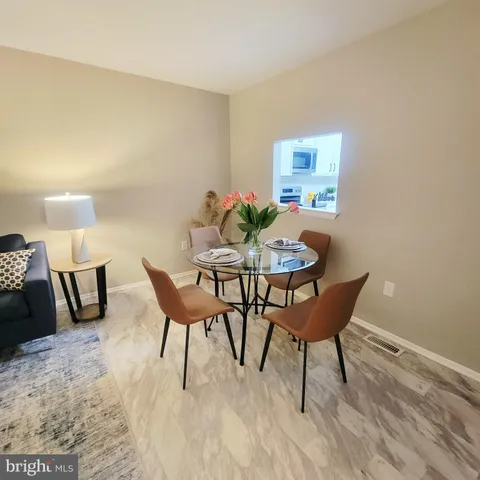 a dining room with furniture and wooden floor