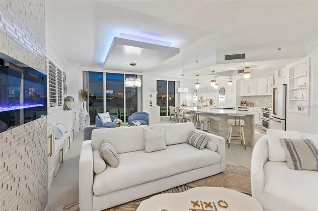 a living room with furniture and a chandelier