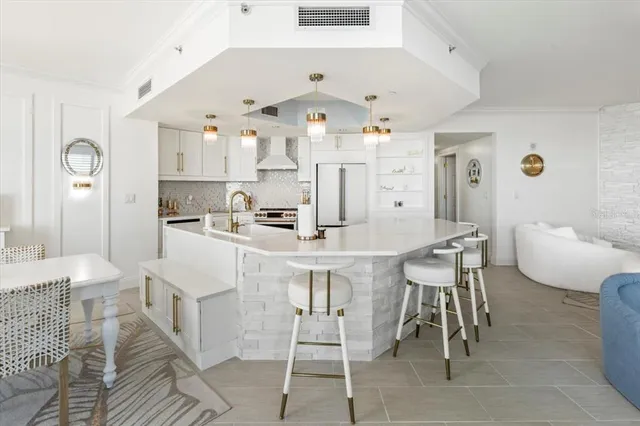 a large white bathroom with a double vanity sink a mirror and a bathtub