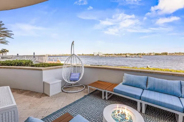 a living room with fireplace furniture and a large window