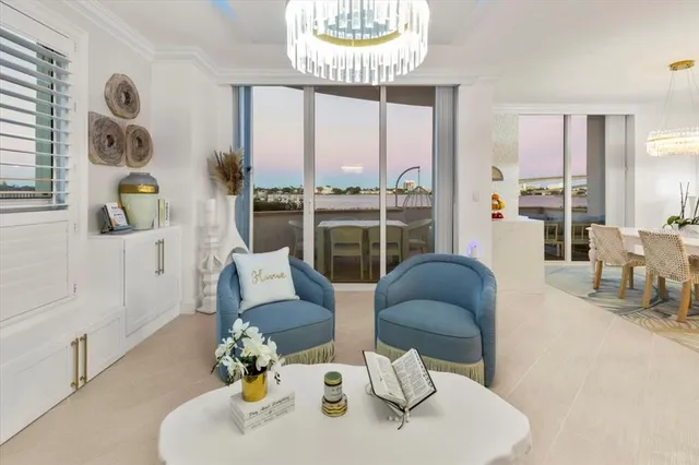 a view of a living room kitchen with stainless steel appliances kitchen island granite countertop furniture and a view of kitchen