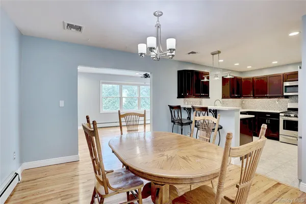 a view of a dining room with furniture window and wooden floor