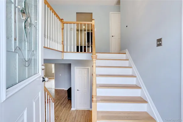 a view of entryway and hall with wooden floor